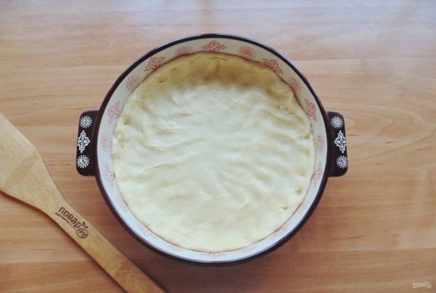 В форму для выпечки выложите тесто, образуя бортики.