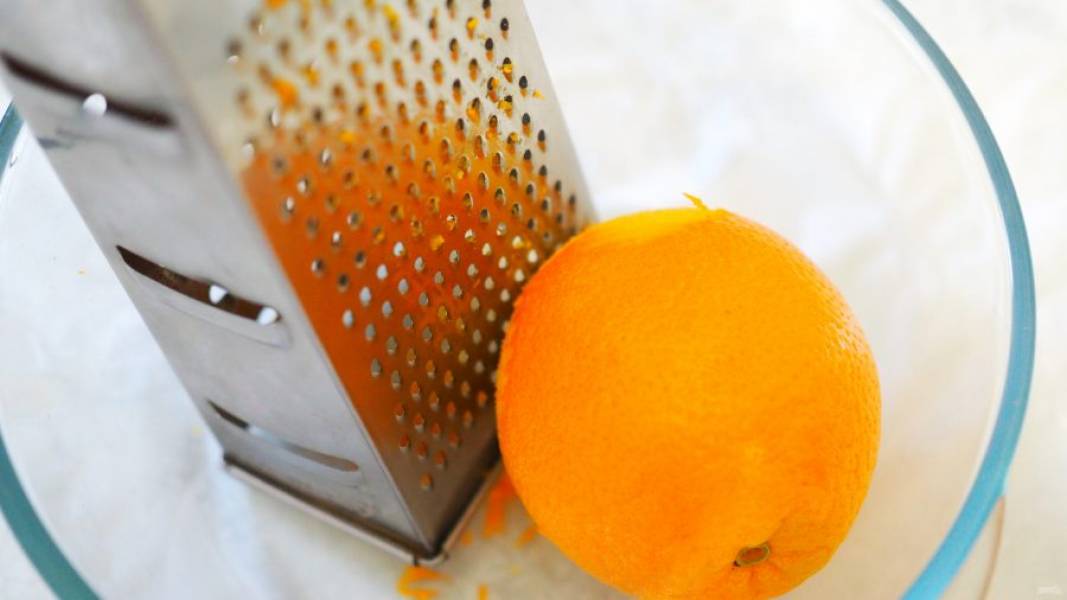 Апельсины тщательно вымойте и снимите с них цедру при помощи мелкой тёрки.