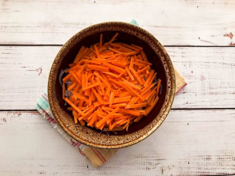 Морковь хорошо помойте под проточной водой, очистите, нарежьте мелкой соломкой и добавьте к фунчозе. 
