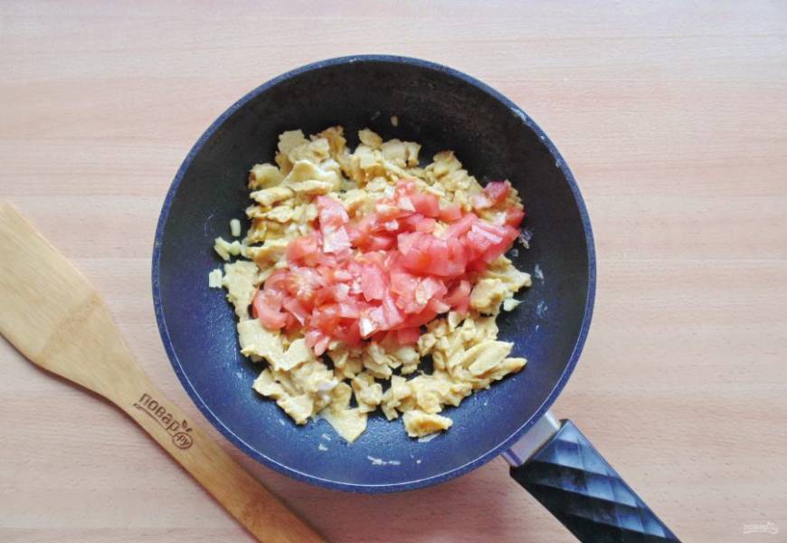 На помидорах сделайте надрезы крест на крест. Залейте кипятком на две-три минуты. После снимите шкурку и мелко нарежьте помидоры. Добавьте в сковороду.