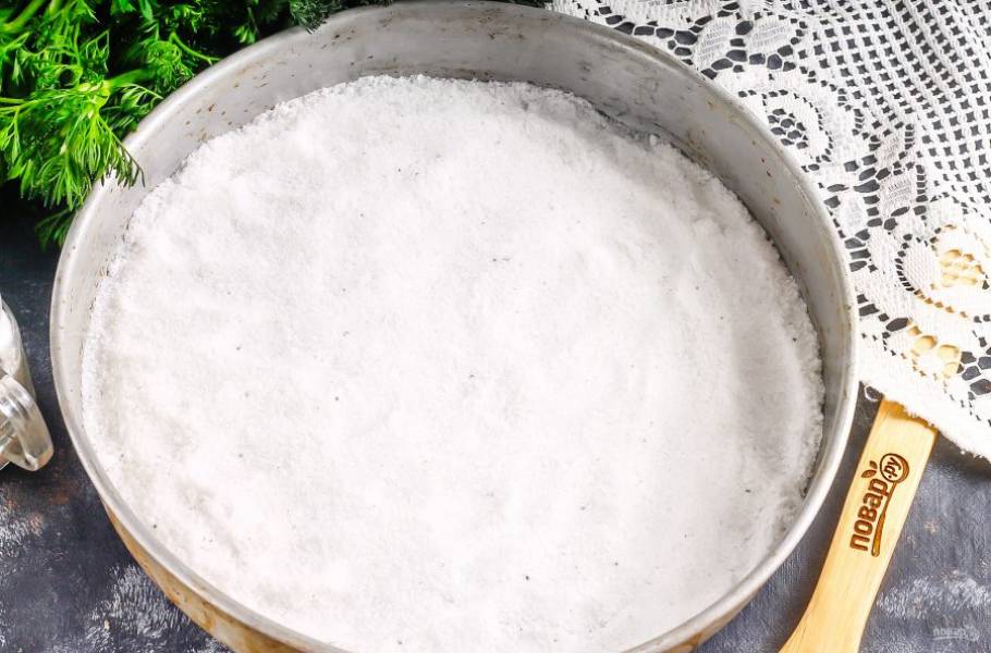 Половину обычной поваренной соли мелкого помола высыпьте в форму и разровняйте. Прогрейте духовку до 200 градусов.