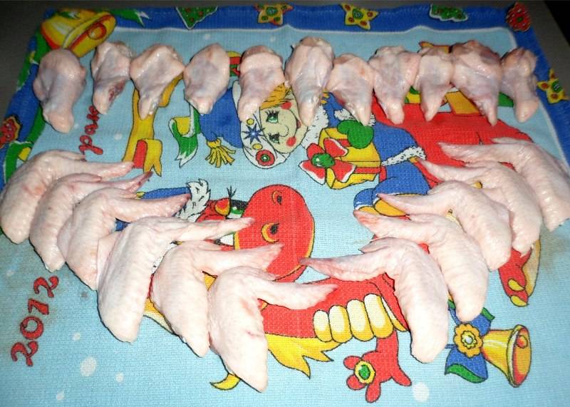 Ну а пока наш соус кипит, мы займемся крылышками, промываем их хорошенько под водой и разрезаем на части. Теперь выкладываем на полотенце и обтираем, чтобы удалить влагу.