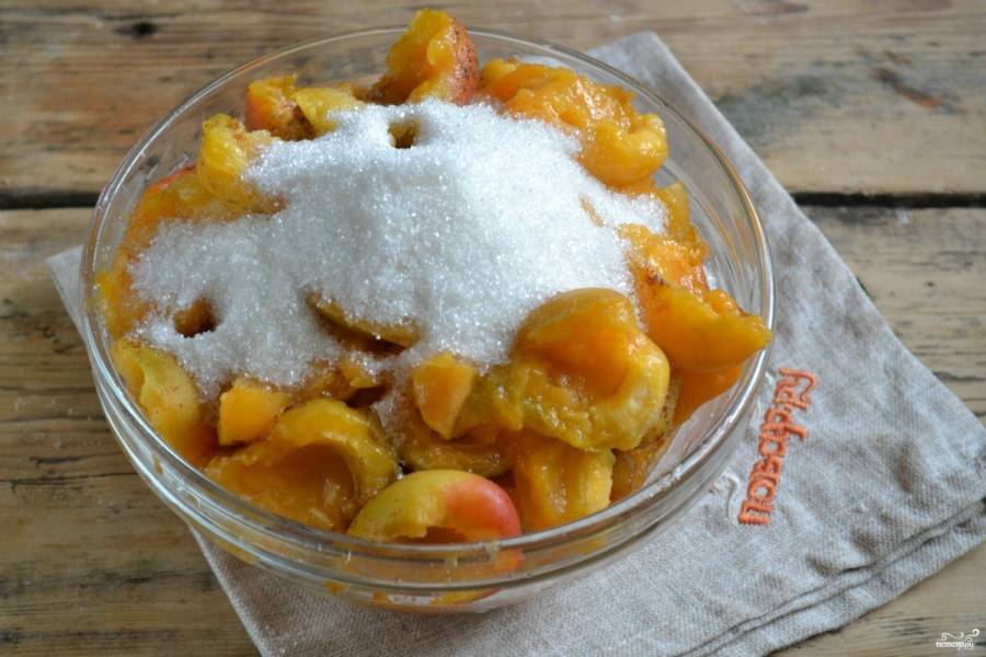 Разделите плоды пополам, удалите косточки. Пересыпьте абрикосы сахаром, оставьте их так на 2 часа, чтобы они пустили сок.