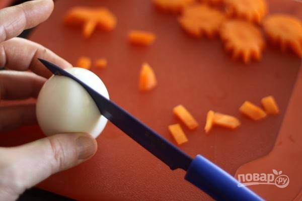 2. Сделайте в яйцах надрезы сверху и поместите в них морковь. 