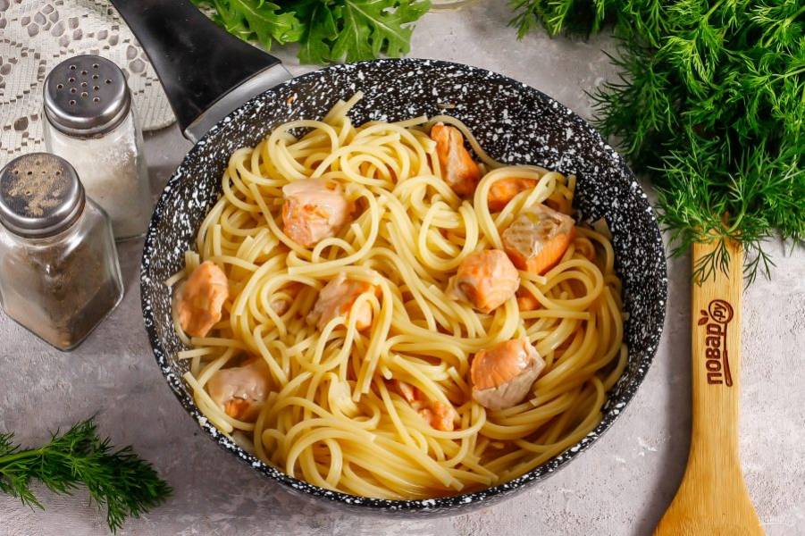 Выложите в сковороду спагетти, откинув их сперва на дуршлаг, чтобы стекла лишняя жидкость. Посолите и поперчите блюдо. Готовьте примерно 1-2 минуты.