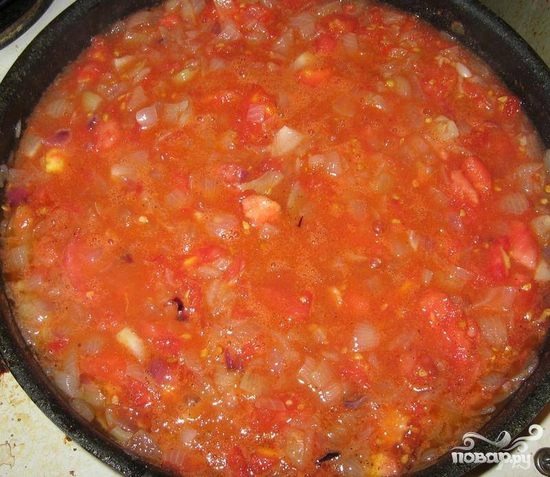 5. Мелко порубить луковицу, обжарить ее в оливковом масле, добавить соль и перец по вкусу, залить томатной массой, получившейся после подготовки помидор. Тушить заливку 10-12 минут, пока она не станет густой.