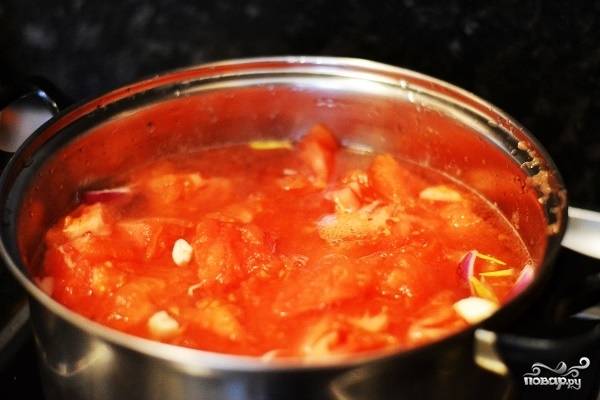 5. После закипания выложите помидоры, уберите огонь до среднего и проварите около 15 минут. 