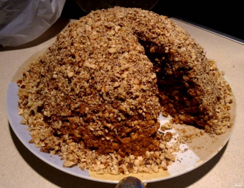 Выкладываем получившуюся массу на тарелку горкой в форме муравейника. Сверху можно обсыпать тортик ореховой крошкой, как я, а можно всыпать мак или потереть шоколад. Ставим в холодильник на ночь, чтобы торт пропитался и схватился. Очень вкусное угощение получилось!