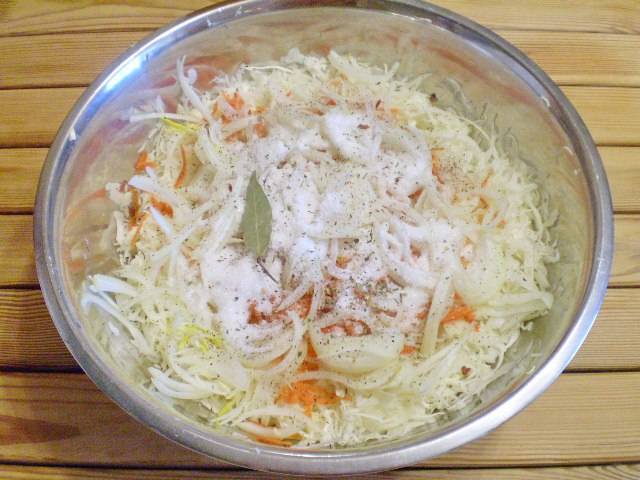 Нашинкуйте тонко лук, натрите на крупной терке морковь. Соедините в глубокой таре капусту, морковь, лук, соль, сахар, специи. Закипятите литр воды.