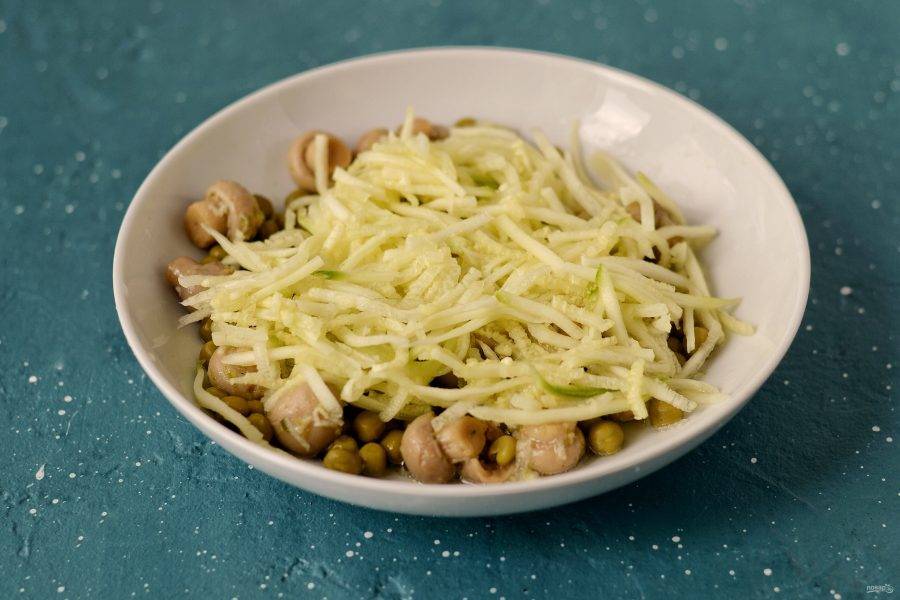 Выложите грибы и горошек в тарелку, добавьте полосы из цукини, перемешайте. Сверху украсьте зеленью, миндальными лепестками и горшком. 