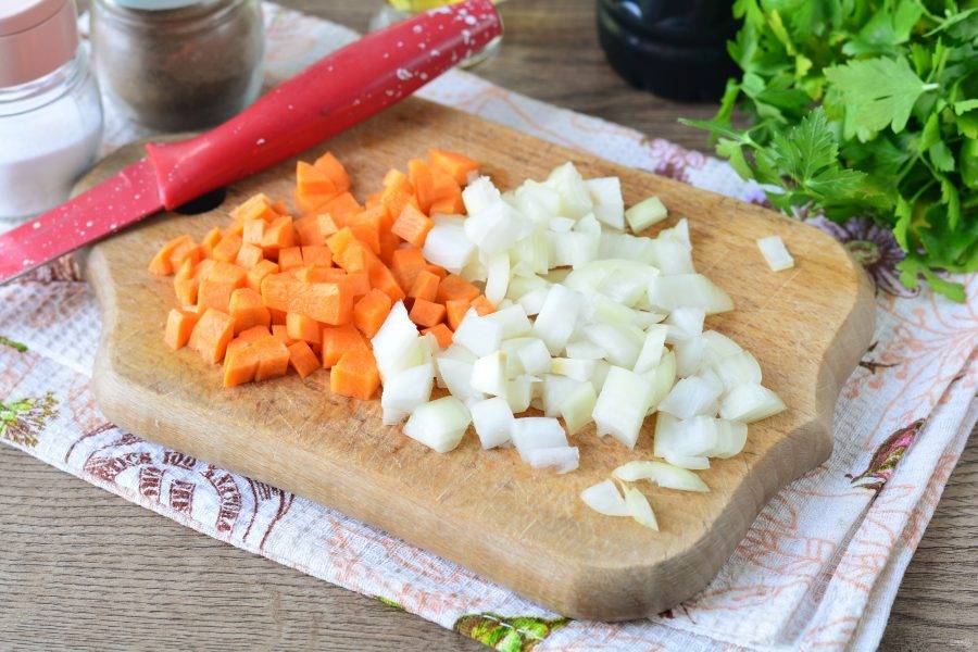 Нарежьте кубиками лук и морковь.