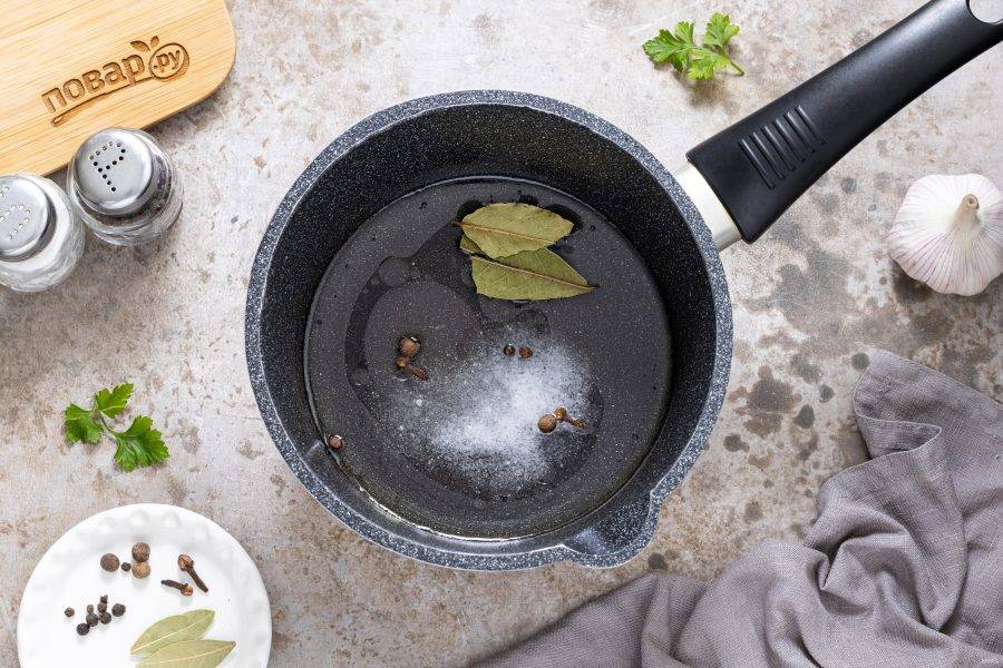 Для маринада влейте воду, уксус и растительное масло в сотейник. Добавьте соль и сахар, перец горошком и лавровый лист. Доведите до кипения.