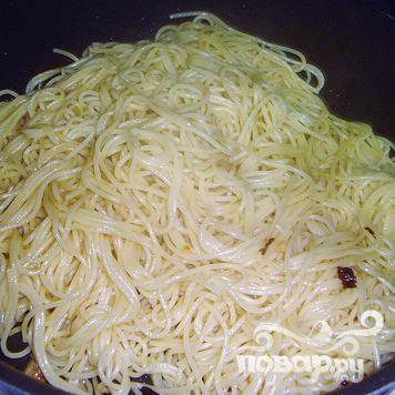Залить спагетти небольшим количеством оставшегося жира и смешать с чесноком. Подавать с отбивными.