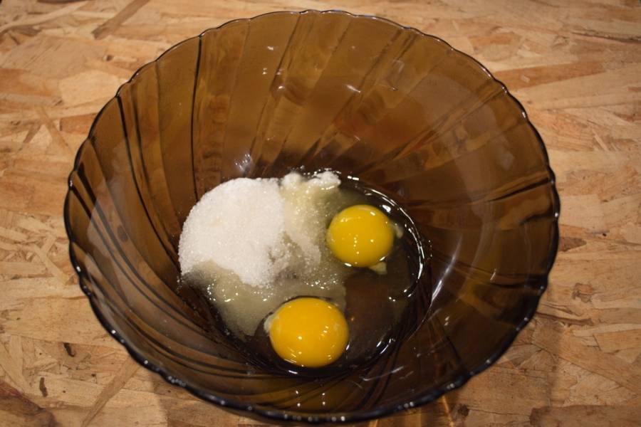 В миску вбиваем 2 яйца. Добавляем сахар, соль и разрыхлитель. Всё хорошенько взбиваем.