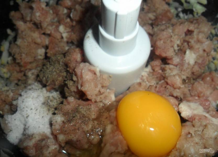 В комбайне измельчите фарш с очищенным и порезанным луком. Затем добавьте к нему яйцо, соль и перец. Ещё раз перемешайте фарш.