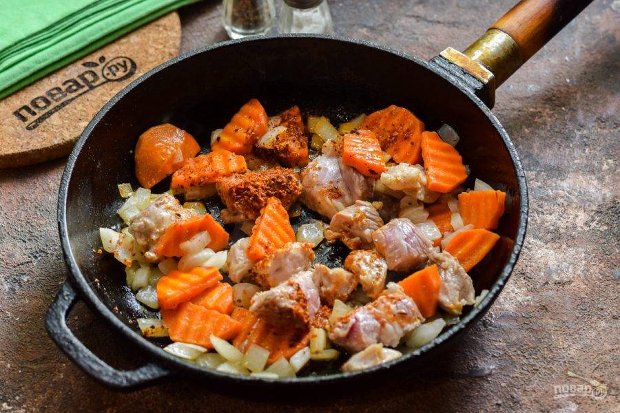 В сковороде прогрейте масло, выложите лук, морковь, мясо. Жарьте 4 минуты, добавьте специи по вкусу.