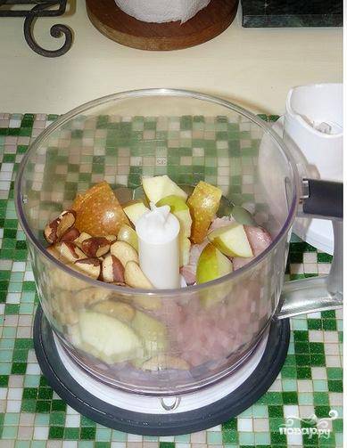 Кладем в чашу блендера кусочки филе индейки, ломтики яблока и орехи.