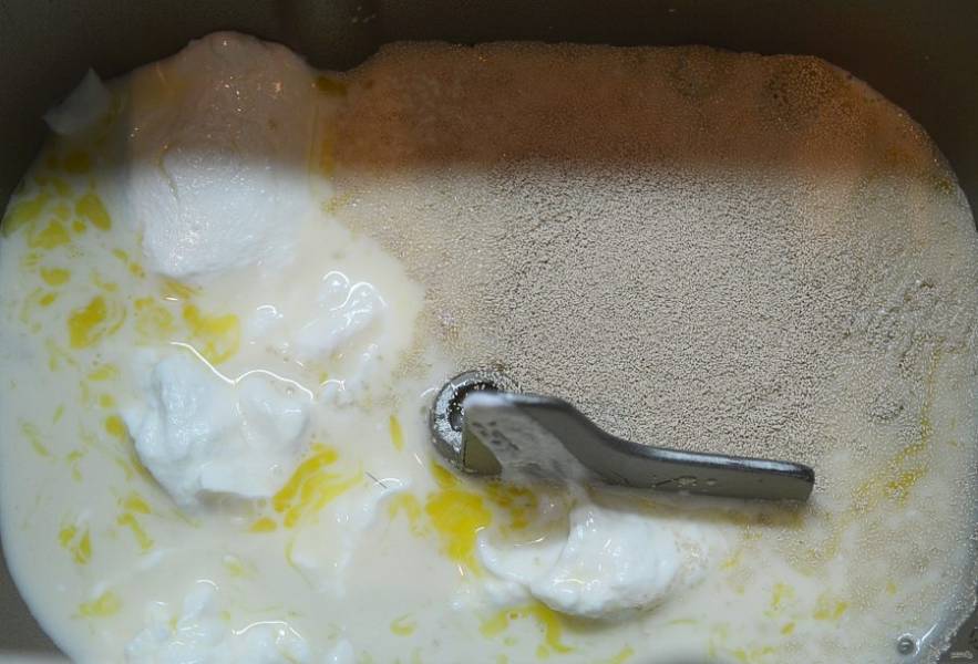 3. В чашу хлебопечки вылейте яичную массу, добавьте творог, сахар и дрожжи.
