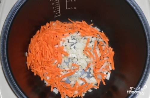 В чашу мультиварки наливаем растительное масло, включаем режим "Пирог" или "Выпечка". Добавляем лук и морковку, обжариваем, помешивая минут 5-7.