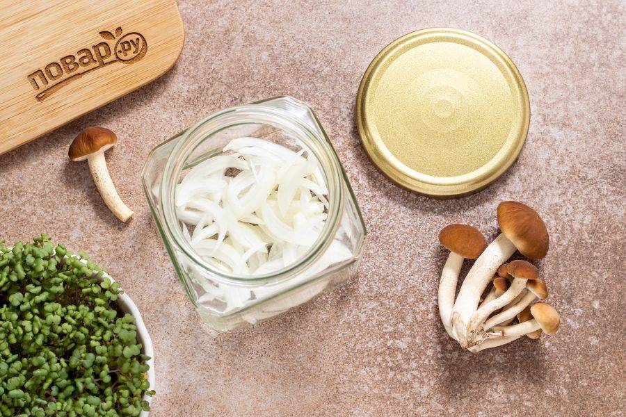 Репчатый лук нарежьте полукольцами. Переложите его в чистую стерилизованную баночку.