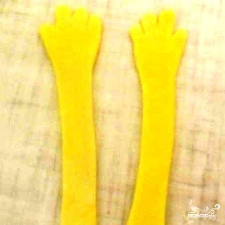 Маникюрными ножницами из желтой мастики вырезаем руки.