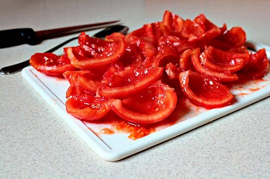 Бланшируйте помидоры в кипящей воде, затем поместите их в холодную воду и снимите кожицу. Нарежьте их небольшими кусочками, удалив семена. 
