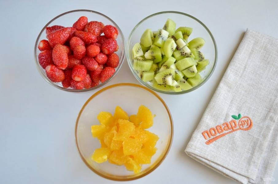 4. Подготовьте ягоды-фрукты: вымойте, очистите киви и апельсин, киви порежьте кусочками, апельсин порежьте кусочками, у клубники оборвите хвостики.