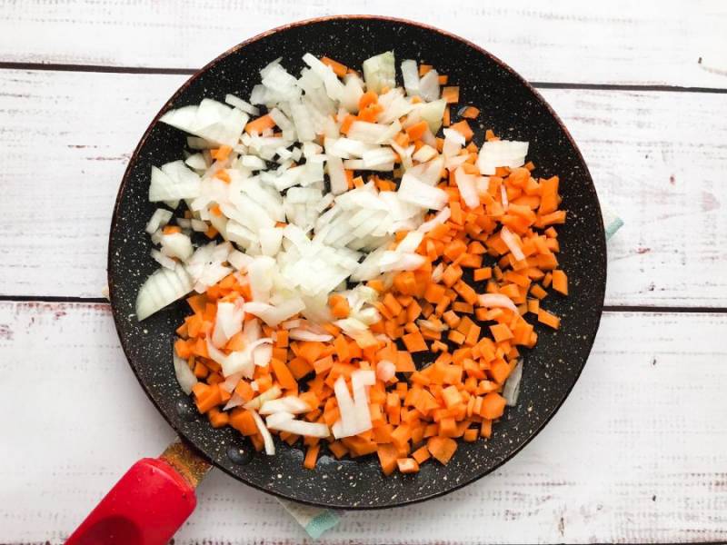 Лук с морковью нарежьте небольшими кусочками и обжарьте в сковороде с небольшим количеством растительного масла до золотистого цвета.