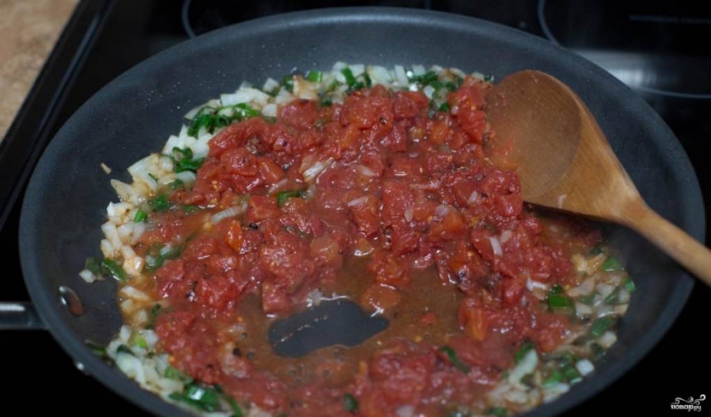 Шаг 6. Добавьте консервированный томат (можно использовать и свежий) в приготовленный лук, готовьте, пока томаты не станут мягкими. 