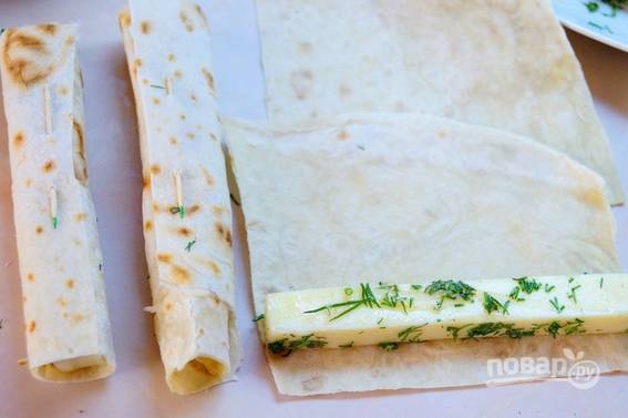 4. Выложите брусочек сыра на лист лаваша, разрезанный предварительно по размеру сыра. Аккуратно сверните. 