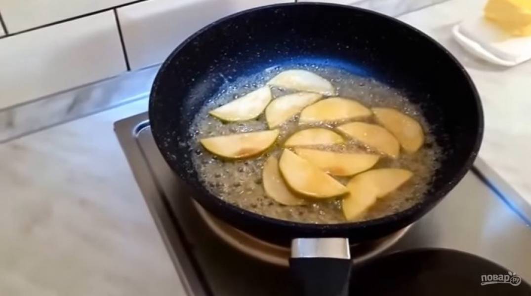 4.Добавьте немного лимонного сока и корицу. Выложите в карамель нарезанные ломтиками яблоки, тушите 3-4 минуты. Выложите готовые яблоки на посуду и дайте им немного остыть. 