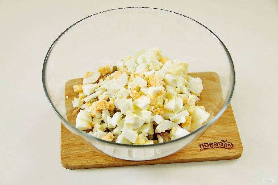 Добавьте нарезанные кубиками вареные яйца.