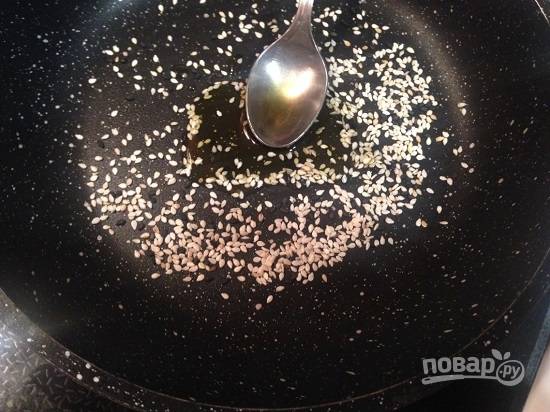На сухой сковороде обжарим кунжутные семечки до легкого подрумянивания, а затем добавим растительное масло и обжариваем еще минутку.