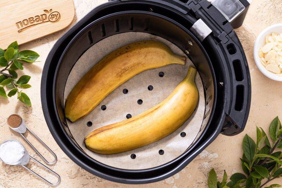 Застелите дно корзины или решетки аэрогриля пергаментом. Выложите банан разрезом вниз. Готовьте 5 минут при температуре 180 градусов.