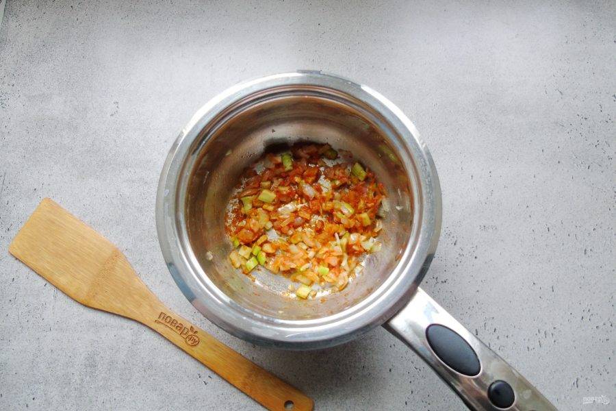 Перемешайте лук, сельдерей, томатную пасту и муку. Тушите перемешивая 2-3 минуты.