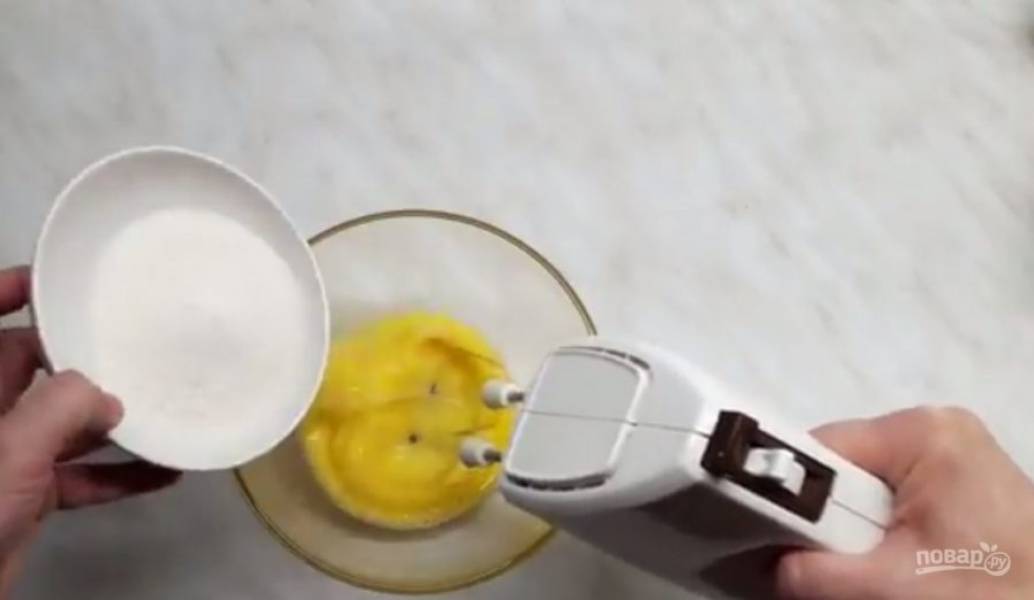 1. Приготовьте бисквит: яйца взбейте на большой скорости вместе с сахаром до пышной массы. Добавьте мягкое сливочное масло, снова взбейте до однородности. Добавьте щепотку соли, просеянную муку, разрыхлитель и ванильный сахар. 
