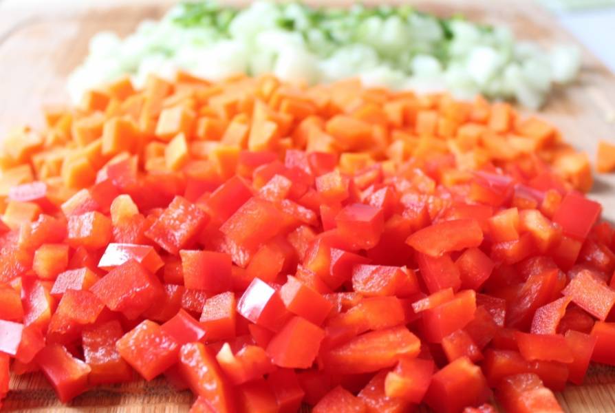 3. Очистите и помойте овощи. Нарежьте мелким кубиком половинку огурца, морковь, перец болгарский, петрушку и несколько веточек зеленого лука, а также измельчите вяленые на солнце помидоры, если будете их использовать.