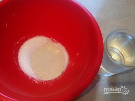 В первую очередь приготовим тесто. Смешаем дрожжи с сахаром и добавим стакан теплого молока или воды. Размешаем и поставим в теплое место.