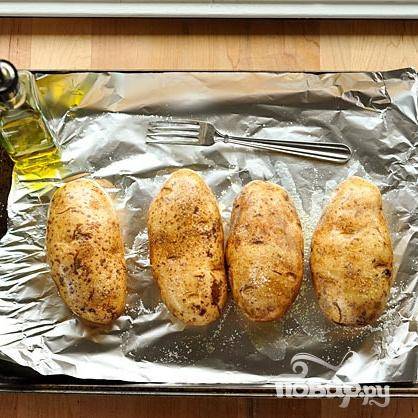 1. Разогреть духовку до 220 градусов. Выстелить противень алюминиевой фольгой. Почистить картофель, полить оливковым маслом и посыпать солью. Наколоть картофель несколько раз вилкой. Выложить картофель  на противень. Выпекать 50-60 минут, пока картофель не станет мягким.