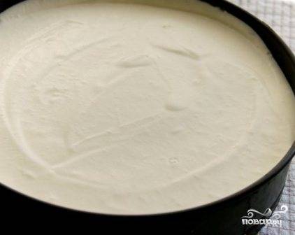 Укладываем корж в форму, а сверху на него выкладываем творожный крем. Ставим в морозилку минут на 15, пусть крем немного застынет.