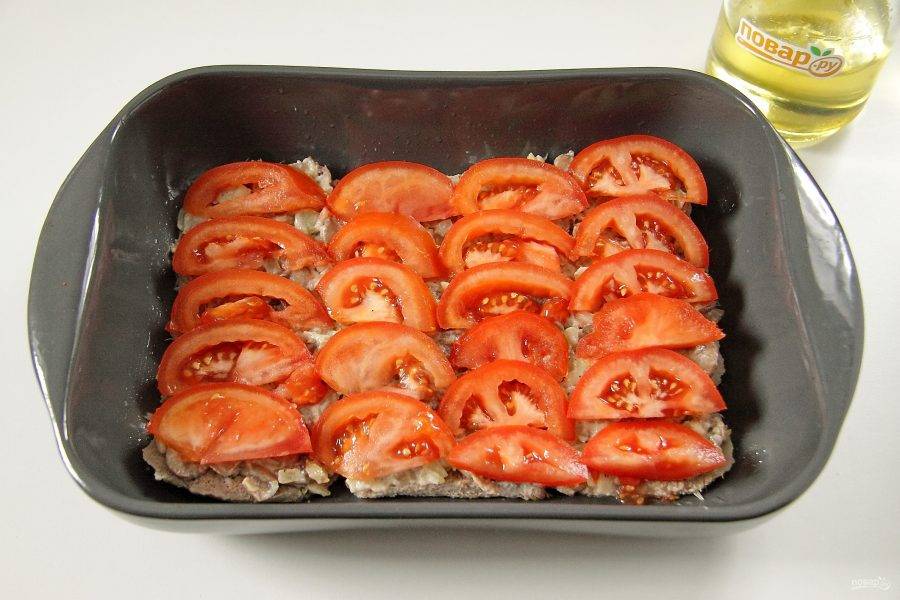 На грибы положите нарезанные помидоры. Посолите и поперчите слой по вкусу.