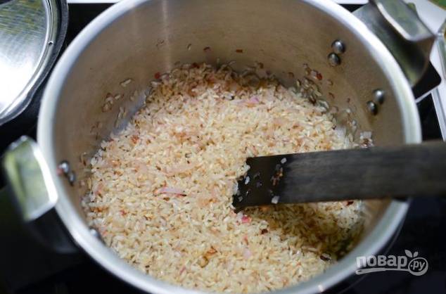 На ложке масла обжарьте измельченный лук до золотистости, добавьте рис и еще ложку масла, обжарьте минут 5.