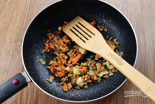 В сковороде разогрейте растительное масло, пассеруйте измельченный лук и морковь в течение 3-4 минут.