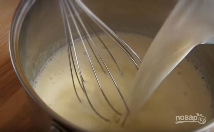 6. Для приготовления крема смешайте в кастрюле яйца с сахаром и мукой. Постепенно влейте холодное молоко, помешивая венчиком получившуюся жидкость. 