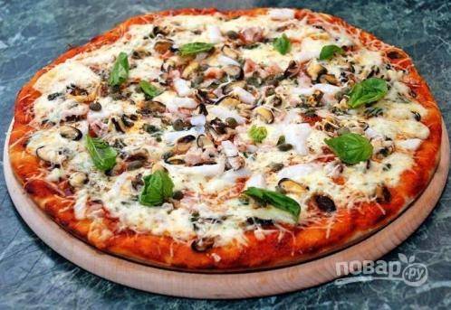 Затем отправляем пиццу в разогретую до 200 градусов духовку на 20 минут (но обязательно следите за тестом). Подавайте пиццу, украсив её листьями базилика. 