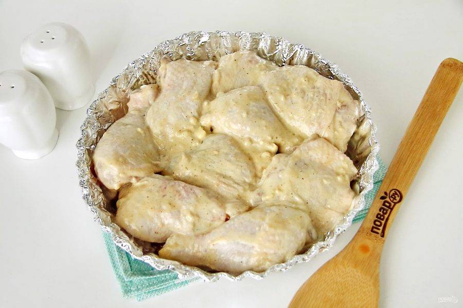 Форму для запекания застелите фольгой, смажьте растительным маслом и выложите маринованные кусочки курицы. Запекайте в духовке при температуре 180 градусов около 40 минут.