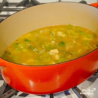 Добавляем бульон, картофель и тыкву. Огонь увеличиваем, доводим суп до кипения, после чего вновь уменьшаем огонь до слабого и варим суп 25-30 минут под крышкой.