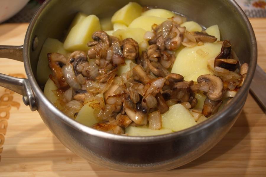 По мере тушения вода уварится и в картофеле почти ее не останется. К готовому картофелю добавляем грибную зажарку и тушим все вместе 10 минут. Добавляем сливочное масло.