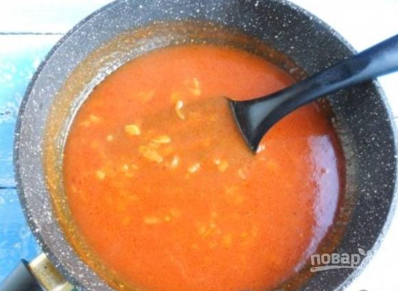 Добавьте томатную пасту и влейте горячую воду, перемешайте. Добавьте сахар, соль и перец. Тушите 5 минут, а затем добавьте измельченный чеснок.