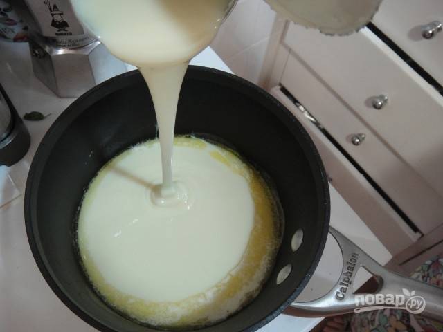 Растопите масло в кастрюльке на медленном огне и добавьте банку сгущенного молока.